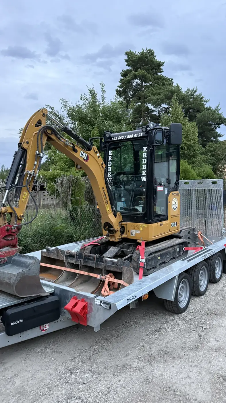 Minibagger auf Anhänger mit LKW von Erdbewegung MG